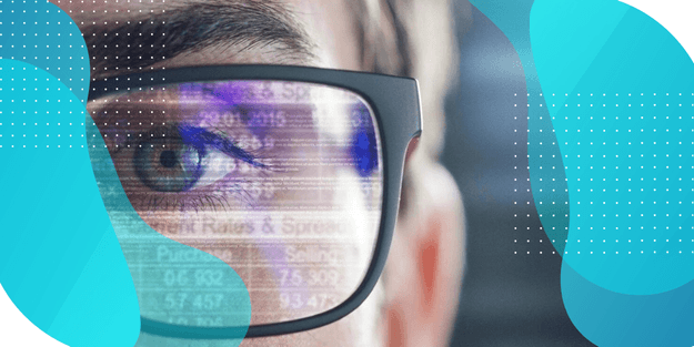 Person wearing glasses with lenses reflecting data and numbers, showcasing how digital forecasting and planning solutions address clinical supply chain issues.