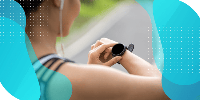 A person outdoors checking their smartwatch, representing the integration of technology use and devices in clinical trial eCOA solutions.