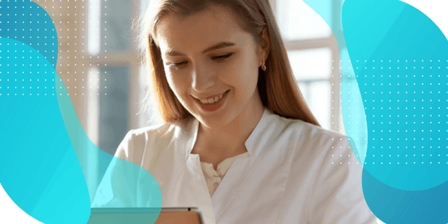 A smiling woman in a lab coat looking at a tablet, representing the exploration of a modular approach to patient-reported outcome measures (PROM) implementation.