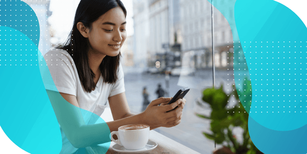  A woman looking at a smartphone, illustrating the benefits and best practices of remote consent in hybrid trials for successful study setup.