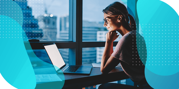 A woman looking at a computer screen, representing the preparation for common scale management challenges in clinical research.